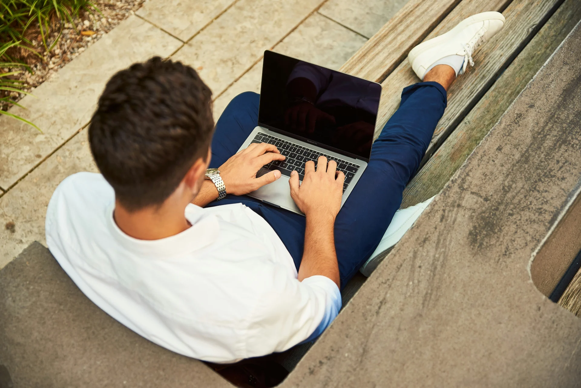 A man working outside with a laptop
