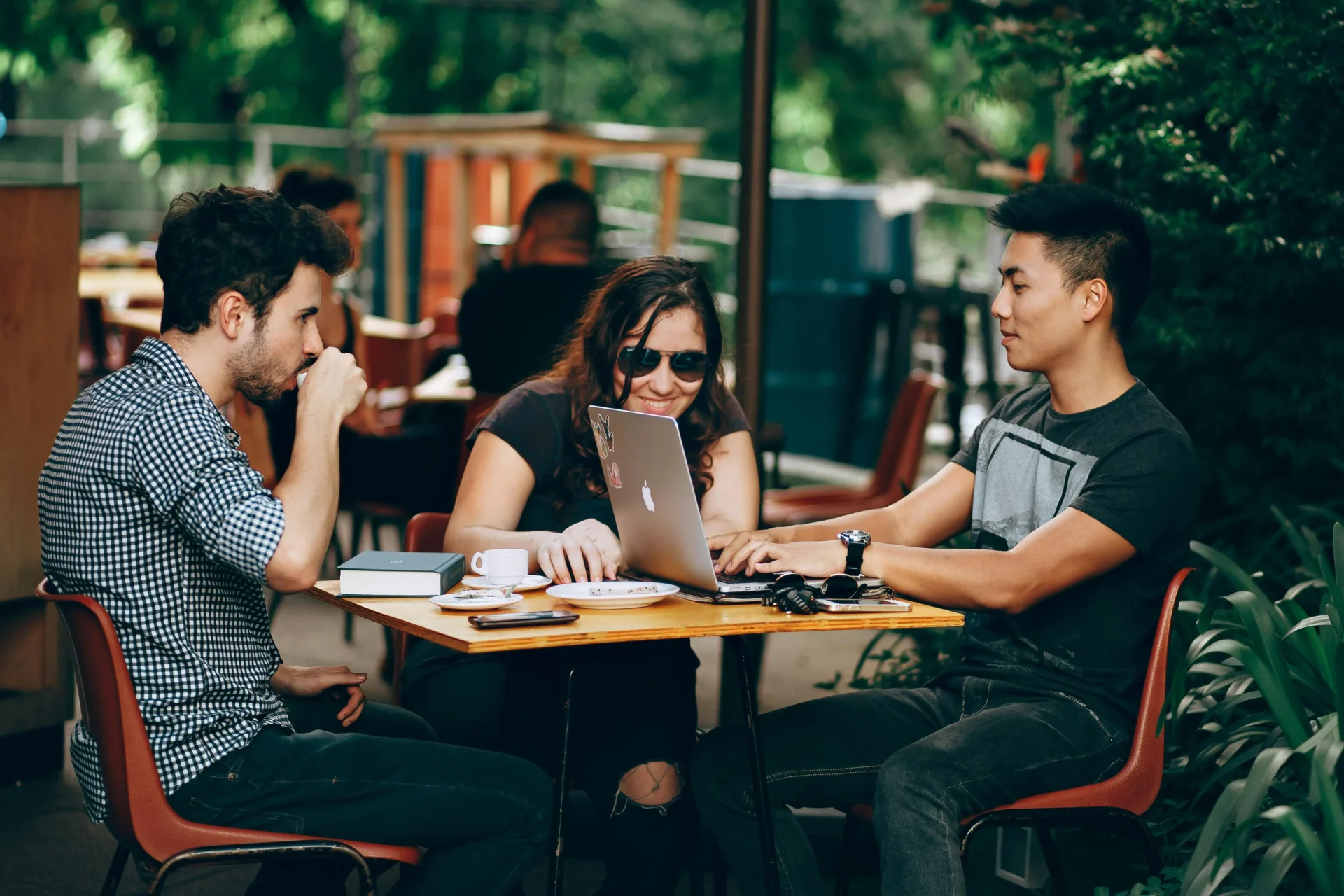 Young group of people working on an outside terrace